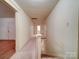 Hallway with carpeted floors, white trim, and natural light leading to the next floor at 113 2Nd St, Spencer, NC 28159
