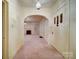 View of the entry hallway with archway leading to a living area with fireplace, offering a warm welcome at 113 2Nd St, Spencer, NC 28159