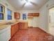 Functional kitchen features wood cabinets, double sink, and neutral countertops at 113 2Nd St, Spencer, NC 28159