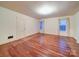 Spacious living room featuring hardwood floors, white trim, and natural light from two windows at 113 2Nd St, Spencer, NC 28159