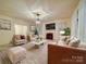 Spacious living room with plush seating, a fireplace, and a large screen television perfect for gatherings at 113 2Nd St, Spencer, NC 28159