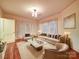 Inviting living room featuring plush seating, hardwood floors, and abundant natural light ideal for relaxation at 113 2Nd St, Spencer, NC 28159