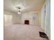 Bright living room featuring a decorative fireplace, neutral walls, and carpet flooring at 113 2Nd St, Spencer, NC 28159