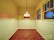 Cozy room featuring red tile floor, vintage light fixture, and bright, natural lighting at 113 2Nd St, Spencer, NC 28159