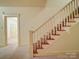 Elegant staircase with carpet runner and classic railing, connecting the home's levels at 113 2Nd St, Spencer, NC 28159