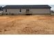 Back of home showcases siding and a small deck leading to a spacious backyard at 133 Plank Barn Ln, Stony Point, NC 28678