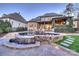 Luxury backyard featuring an outdoor kitchen, large pool, and lush landscaping at 17639 Stuttgart Rd, Davidson, NC 28036