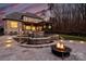 A gorgeous backyard featuring a patio, pool with waterfall, putting green, and fire pit, perfect for outdoor entertaining at 17639 Stuttgart Rd, Davidson, NC 28036