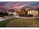 Beautiful backyard with custom pool, putting green, and patio area perfect for outdoor entertaining at 17639 Stuttgart Rd, Davidson, NC 28036