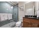 Bathroom features a glass shower, wood vanity with dark countertops, and decorative mirror at 17639 Stuttgart Rd, Davidson, NC 28036