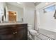 Bright bathroom featuring a granite countertop, dark vanity, and tub/shower combo at 17639 Stuttgart Rd, Davidson, NC 28036