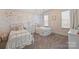 Charming bedroom with twin beds, floral wallpaper, and soft, natural light at 17639 Stuttgart Rd, Davidson, NC 28036