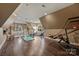 Spacious bonus room with hardwood floors, a bookcase, and fitness equipment at 17639 Stuttgart Rd, Davidson, NC 28036