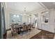 Formal dining room with wainscoting, chandelier, and views of a grand living space, ideal for entertaining guests at 17639 Stuttgart Rd, Davidson, NC 28036