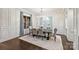 Formal dining room with wainscoting, chandelier, and large window, creating an elegant space for gatherings at 17639 Stuttgart Rd, Davidson, NC 28036