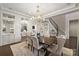 Formal dining room featuring elegant millwork, a chandelier, and seamless access to other living areas at 17639 Stuttgart Rd, Davidson, NC 28036