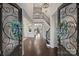 Grand foyer showcasing soaring ceilings, dark hardwood floors, and an elegant staircase with iron railings at 17639 Stuttgart Rd, Davidson, NC 28036