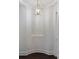 Entry hallway features a decorative gold light fixture and niche for displaying art at 17639 Stuttgart Rd, Davidson, NC 28036