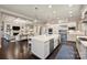 Spacious kitchen with a center island, stainless steel appliances, and hardwood floors, adjacent to the living room at 17639 Stuttgart Rd, Davidson, NC 28036