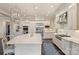Open kitchen featuring stainless steel appliances, a large island with seating, and hardwood flooring at 17639 Stuttgart Rd, Davidson, NC 28036