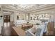 Bright and open living room with coffered ceilings flowing into the kitchen, ideal for modern living and entertaining at 17639 Stuttgart Rd, Davidson, NC 28036