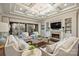 Spacious living room features coffered ceilings, a fireplace, and large windows, providing a bright and airy space at 17639 Stuttgart Rd, Davidson, NC 28036