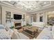Comfortable living room with a fireplace, built-in bookshelves, and coffered ceilings, offering a cozy and stylish retreat at 17639 Stuttgart Rd, Davidson, NC 28036