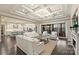 Spacious living room open to the kitchen, features coffered ceilings, hardwood floors, and sliding glass doors to outdoor living at 17639 Stuttgart Rd, Davidson, NC 28036
