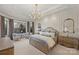 Spacious main bedroom with natural light, tray ceiling, chandelier, and stylish furniture at 17639 Stuttgart Rd, Davidson, NC 28036