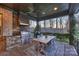 Outdoor kitchen featuring stone accents, stainless steel grill, and a dining area at 17639 Stuttgart Rd, Davidson, NC 28036