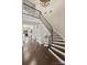 Elegant curved staircase with dark wood steps and iron railing in a grand foyer with high ceilings at 17639 Stuttgart Rd, Davidson, NC 28036