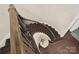 Detailed staircase offers dark wood steps, black railings, and a small table with flowers at 17639 Stuttgart Rd, Davidson, NC 28036
