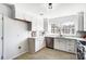 Spacious white kitchen featuring stainless steel appliances, a double-basin sink and bright natural light at 2146 Mallard Green Pl, Charlotte, NC 28262