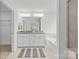 Luxurious bathroom featuring a double sink vanity, soaking tub, and elegant finishes at 2461 Palmdale Walk Dr, Fort Mill, SC 29708