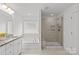 Modern bathroom with a vanity, soaking tub, and a glass-enclosed shower at 2461 Palmdale Walk Dr, Fort Mill, SC 29708