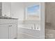 Elegant bathroom featuring a vanity and a large soaking tub at 2461 Palmdale Walk Dr, Fort Mill, SC 29708