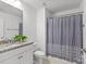 Bathroom featuring granite countertop, white cabinets, and shower with patterned curtain at 2461 Palmdale Walk Dr, Fort Mill, SC 29708