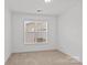 Bedroom with neutral carpet and a window providing natural light overlooking the neighborhood at 2461 Palmdale Walk Dr, Fort Mill, SC 29708
