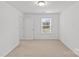 Bedroom with neutral carpet, white walls, and a window at 2461 Palmdale Walk Dr, Fort Mill, SC 29708