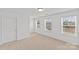 Bedroom with three windows providing ample natural light and neutral carpeting at 2461 Palmdale Walk Dr, Fort Mill, SC 29708