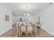 Bright dining area featuring hardwood floors and views into the modern kitchen at 2461 Palmdale Walk Dr, Fort Mill, SC 29708