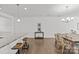 Open-concept dining room with wood floors, chandelier, and granite countertop kitchen island at 2461 Palmdale Walk Dr, Fort Mill, SC 29708