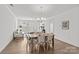Bright dining room with chandelier, wood floors, and woven chairs at 2461 Palmdale Walk Dr, Fort Mill, SC 29708