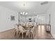 Open-concept dining room with wood floors, chandelier, and view of the kitchen at 2461 Palmdale Walk Dr, Fort Mill, SC 29708