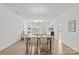 Elegant dining room with a view of the living room, featuring wood floors and a chandelier at 2461 Palmdale Walk Dr, Fort Mill, SC 29708