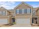 Charming townhome with stone accents, two-car garage, and blue shutters at 2461 Palmdale Walk Dr, Fort Mill, SC 29708