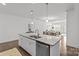 Bright kitchen island with granite countertop, double sink, and stainless steel dishwasher at 2461 Palmdale Walk Dr, Fort Mill, SC 29708