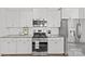 Modern kitchen features white cabinets, subway tile backsplash, and stainless steel appliances at 2461 Palmdale Walk Dr, Fort Mill, SC 29708