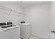 Bright laundry room featuring modern washer and dryer, with wire shelving for convenient storage at 2461 Palmdale Walk Dr, Fort Mill, SC 29708