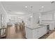 Open-concept living area with hardwood floors connecting living, dining and kitchen at 2461 Palmdale Walk Dr, Fort Mill, SC 29708
